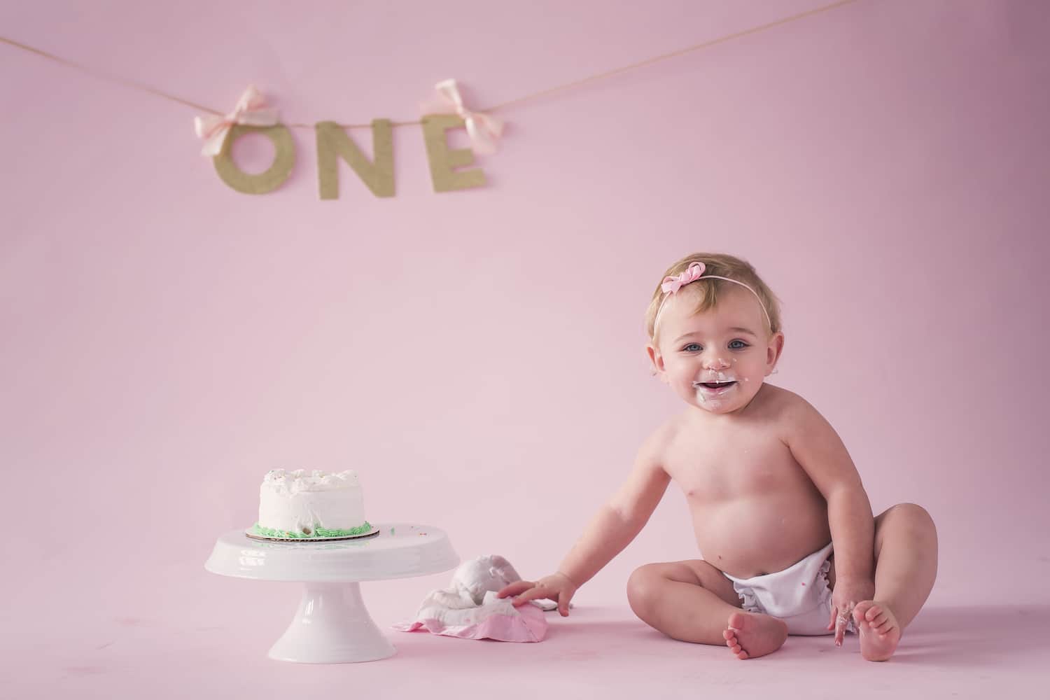 In this in-depth video tutorial, you'll learn how to plan, produce, light, market, price, and retouch newborn photography shoots for 5 different stages of a baby's first year. Includes post-production workflows so that you can create an experience your clients will love. 12 month cake shot idea for newborns. Posing and lighting tutorials for photographers online.